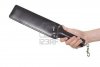 5072141-strict-leather-black-paddle-in-man-s-hand-isolated-over-white-background.jpg
